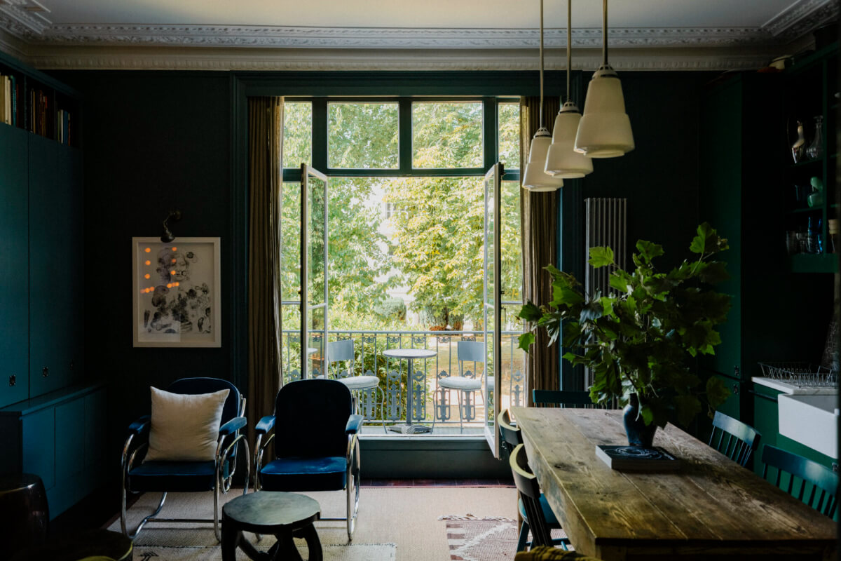dark blue open-plan living room with balcony