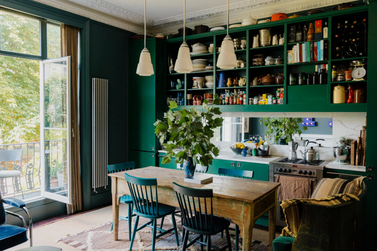 green kitchen open upper cabinets rustic wooden table