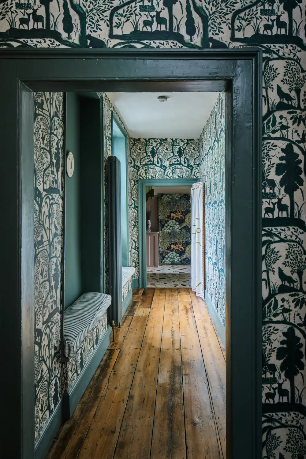 A Colorful Design-Led Georgian House in the Heart of Henley-on-Thames 15 hall-window-seat-the-enchanted-woodland-wallpaper-mind-the-gap-nordroom