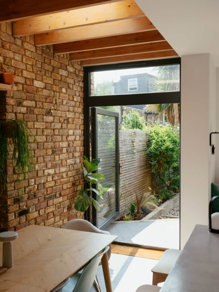View of Exposed Brick and Wooden Beams in an Extended London Home - The Nordroom