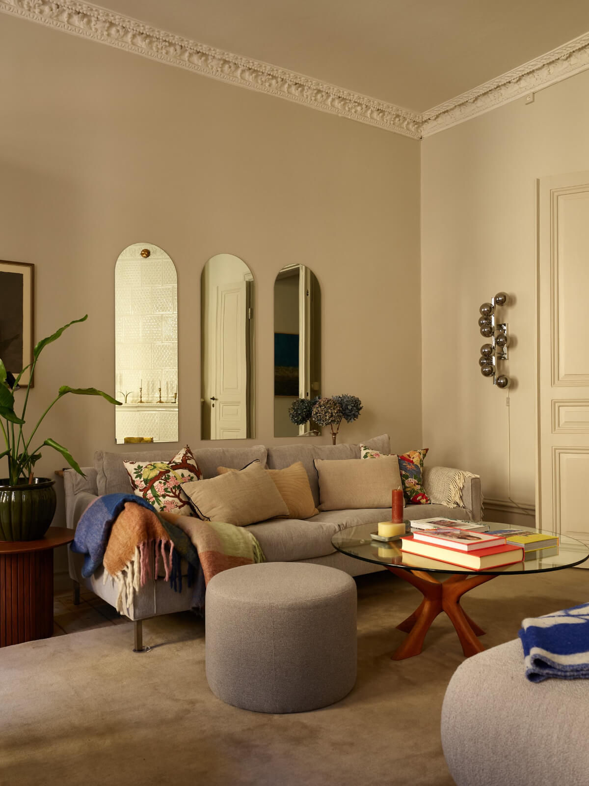 arched mirrors above gray sofa