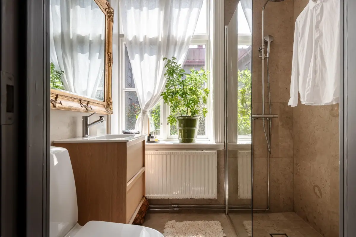 A Dark Gray Swedish Apartment with an Olive Green Kitchen 21 bathroom gilded mirror