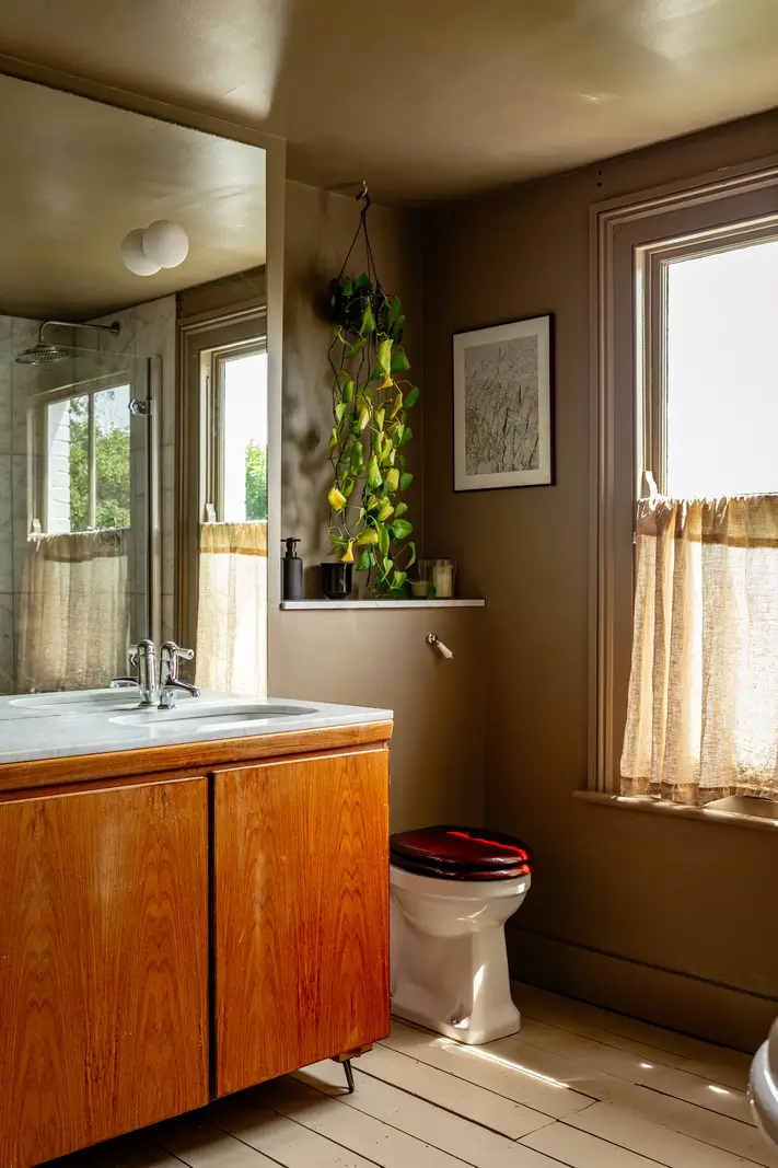 A Muted Color Palette and Original Details in a Victorian Terrace House 18 bathroom painted wooden floorboards