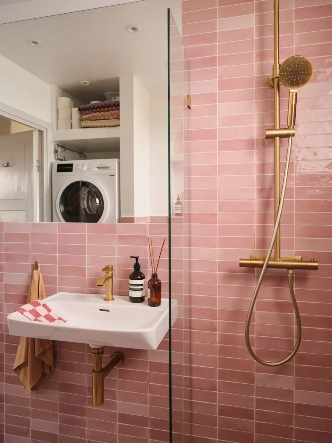 A Pink Bathroom and a Plywood Kitchen in a Stockholm Apartment 23 bathroom pink tiles brass fittings A Pink Bathroom and a Plywood Kitchen in a Stockholm Apartment