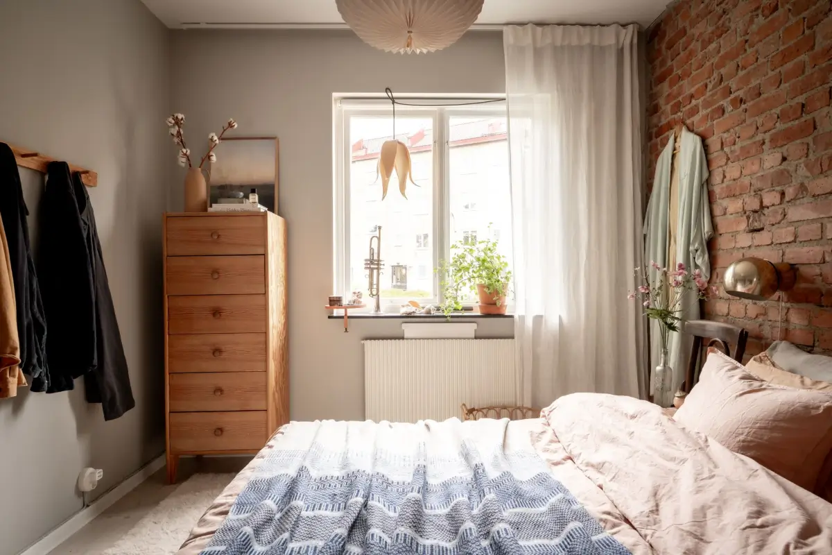 An Earthy Color Palette and Exposed Brick in a 1940s Apartment 18 bedroom exposed brick feature wall nordroom