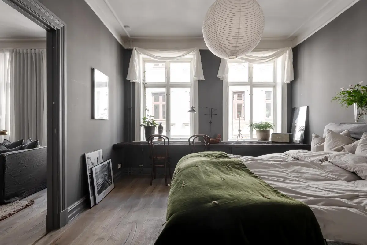 A Dark Gray Swedish Apartment with an Olive Green Kitchen 16 bedroom gray walls built-in desk under window