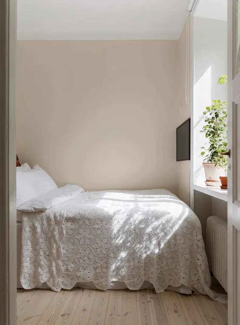 A Red Kitchen in a Small and Light Scandinavian Apartment 13 beige bedroom wooden floor