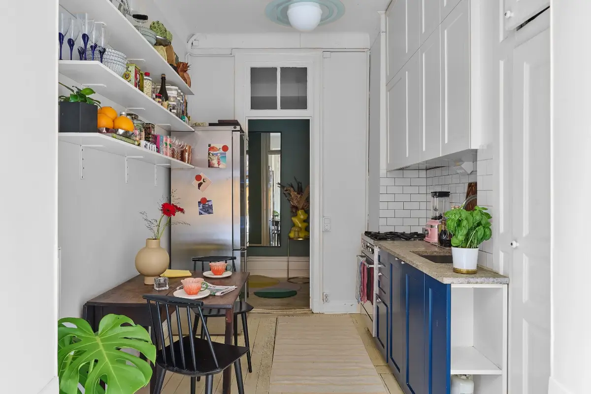 A Colorful Stockholm Apartment with a Large Terrace 13 blue and white kitchen cabinets