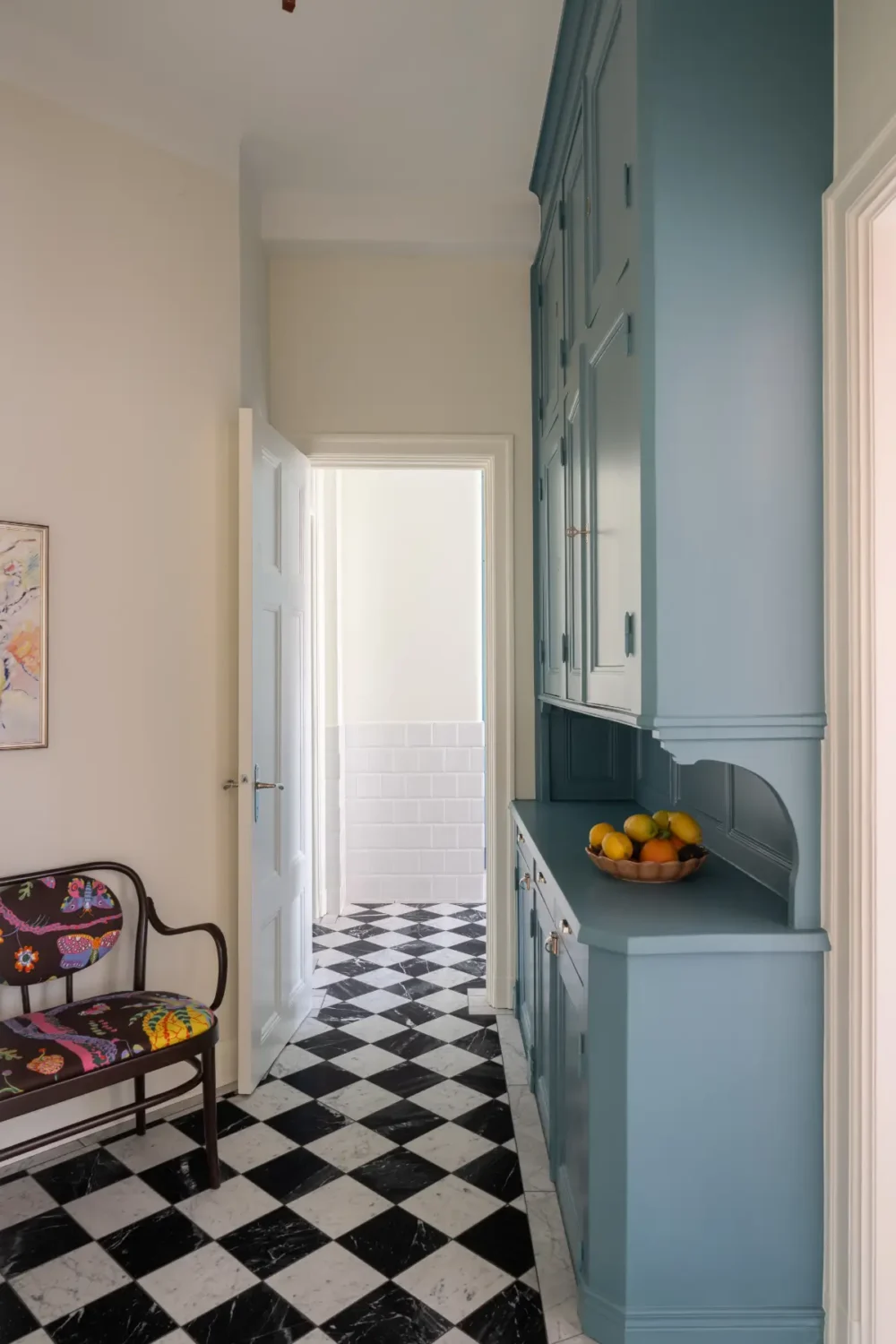 A Classic Stockholm Apartment with a Sky-Blue Kitchen 8 blue cabinets kitchen marble checkerboard floor tiles nordroom