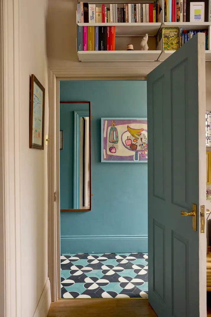 A Victorian Home with a Rich Color Palette and a Lush Garden 13 blue hall