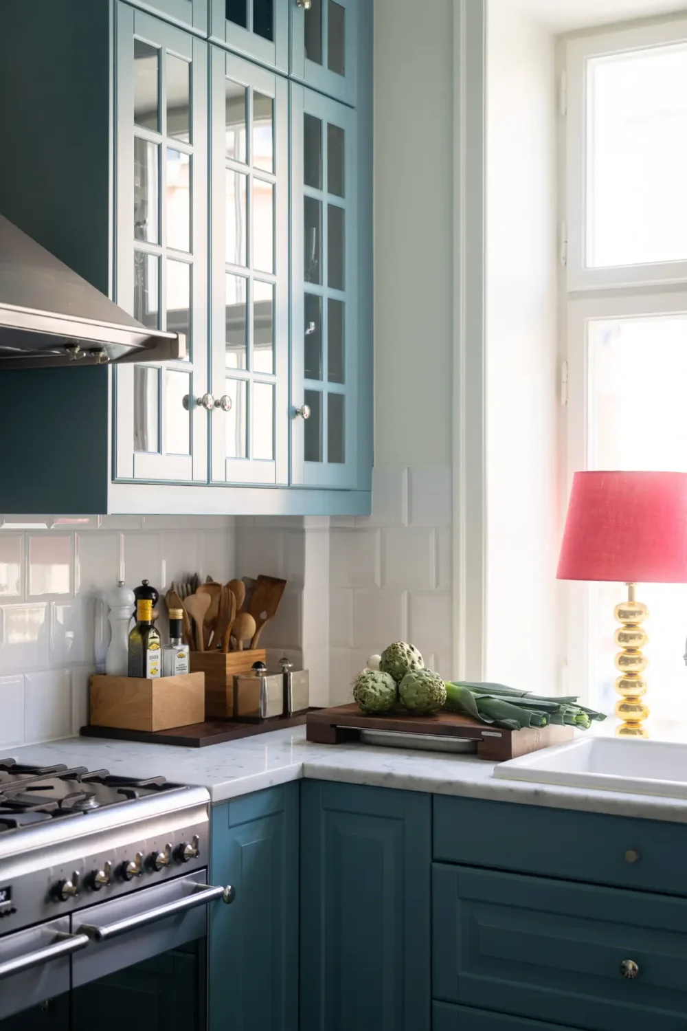 A Classic Stockholm Apartment with a Sky-Blue Kitchen 6 blue kitchen cabinets white backsplash tiles nordroom