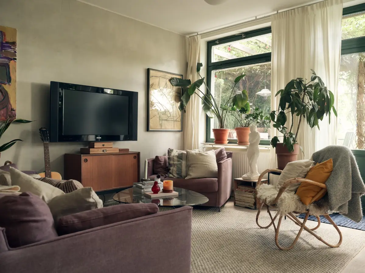 Industrial Elements in a 1960s Duplex Apartment in Stockholm 3 cozy scandi living room purple furniture