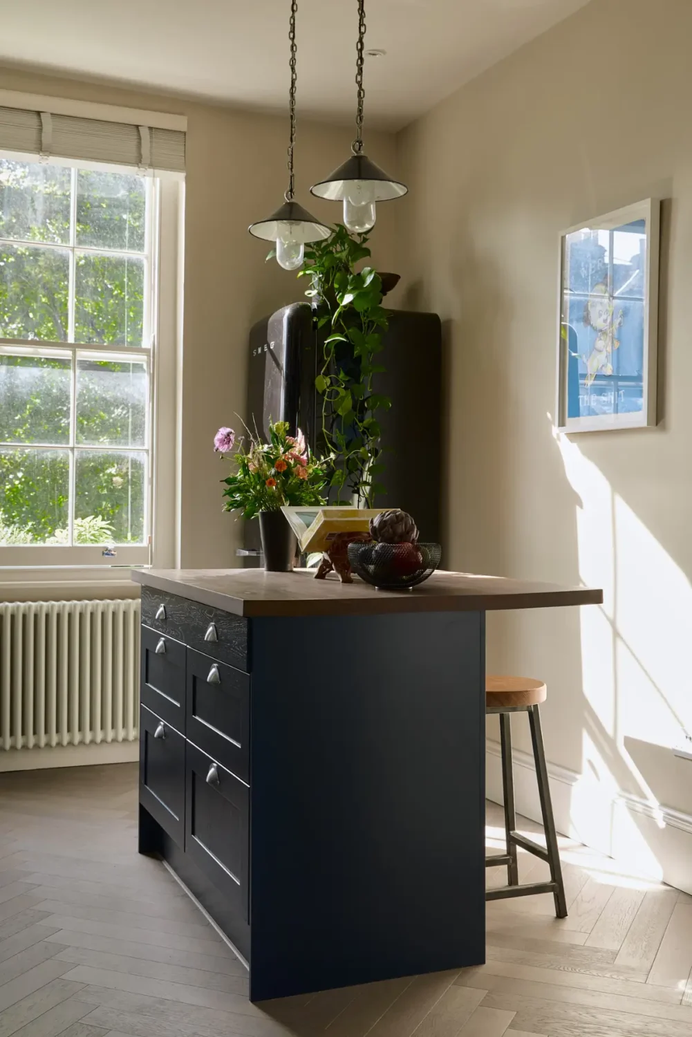 A Classic Victorian Duplex with a Lush, Private Garden in London 14 dark blue kitchen island