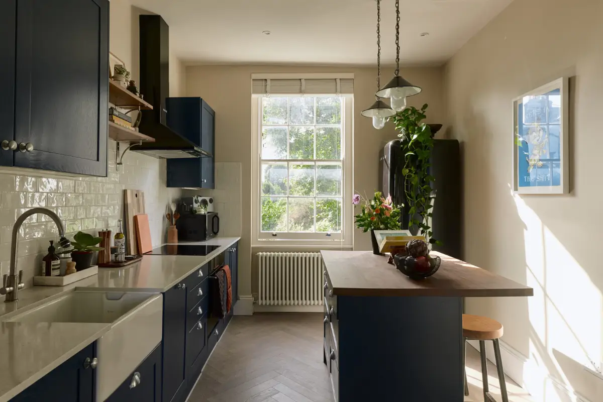 A Classic Victorian Duplex with a Lush, Private Garden in London 10 dark blue kitchen with island