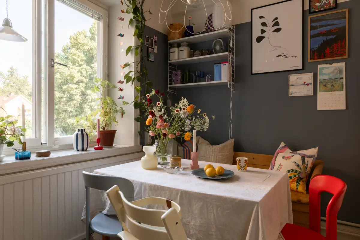 A Cozy Colorful Family Apartment with an Industrial Room Divider 12 dark blue wall kitchen table nook nordroom