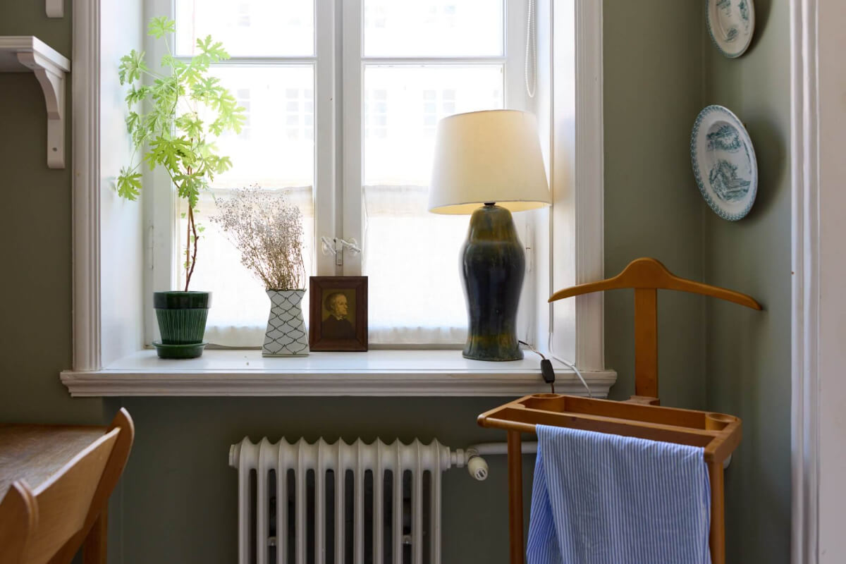 A Blue Living Room Filled with Art in a Swedish Apartment 17 deep window niches