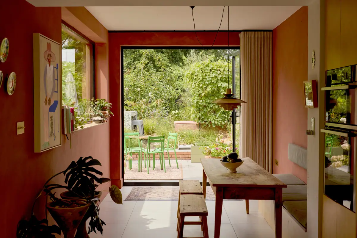 A Victorian Home with a Rich Color Palette and a Lush Garden 11 dining space rustic table terracotta colored walls