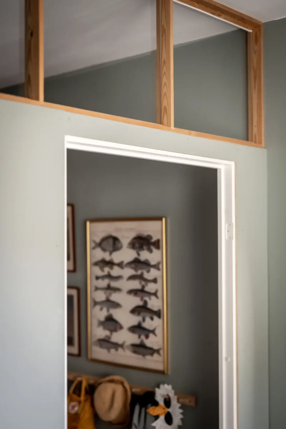 An Earthy Color Palette and Exposed Brick in a 1940s Apartment 27 doorway with window