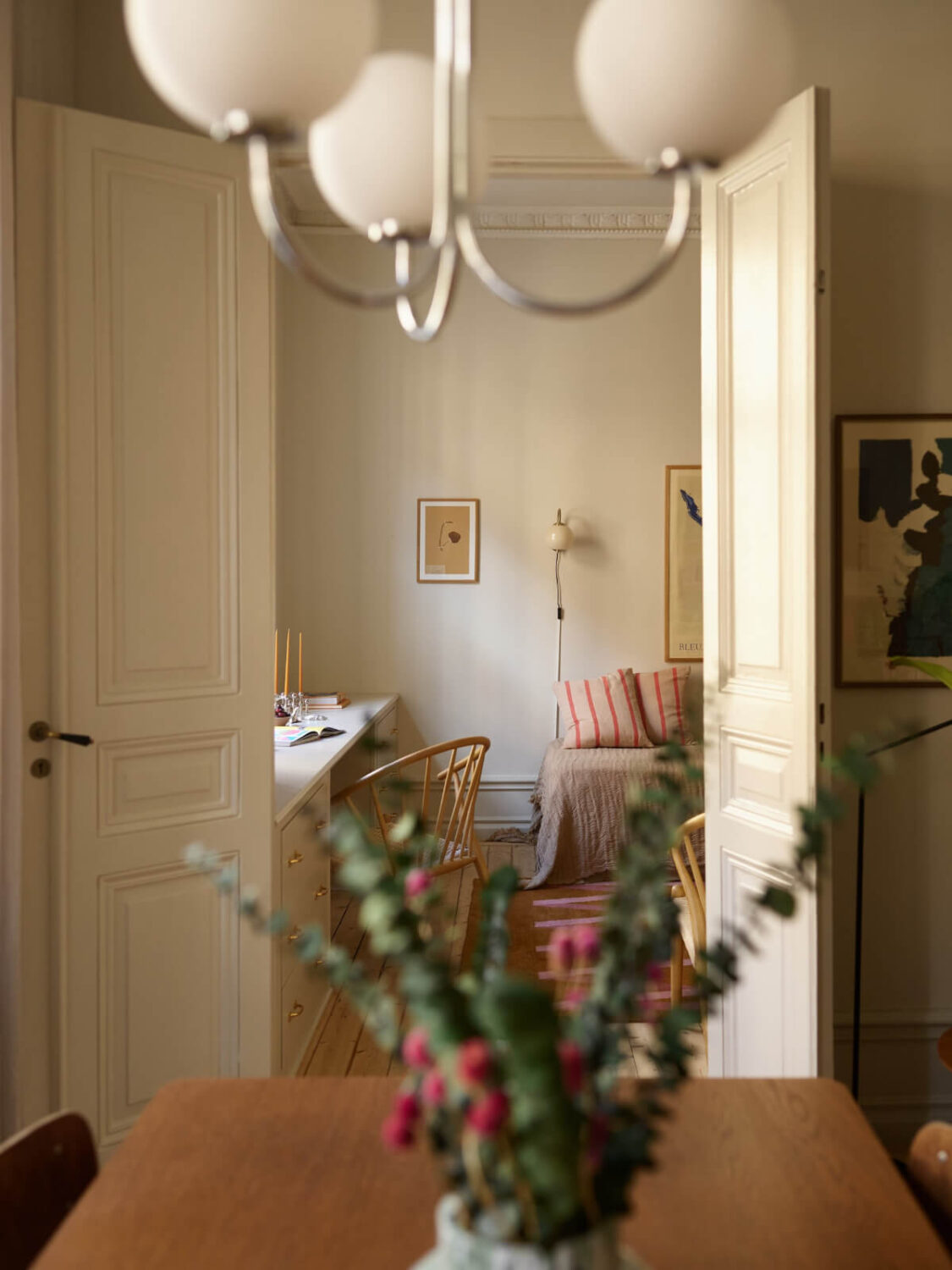 Blue and Red Color Accents in a Stylish Scandinavian Apartment 11 double doors view into guest bedroom