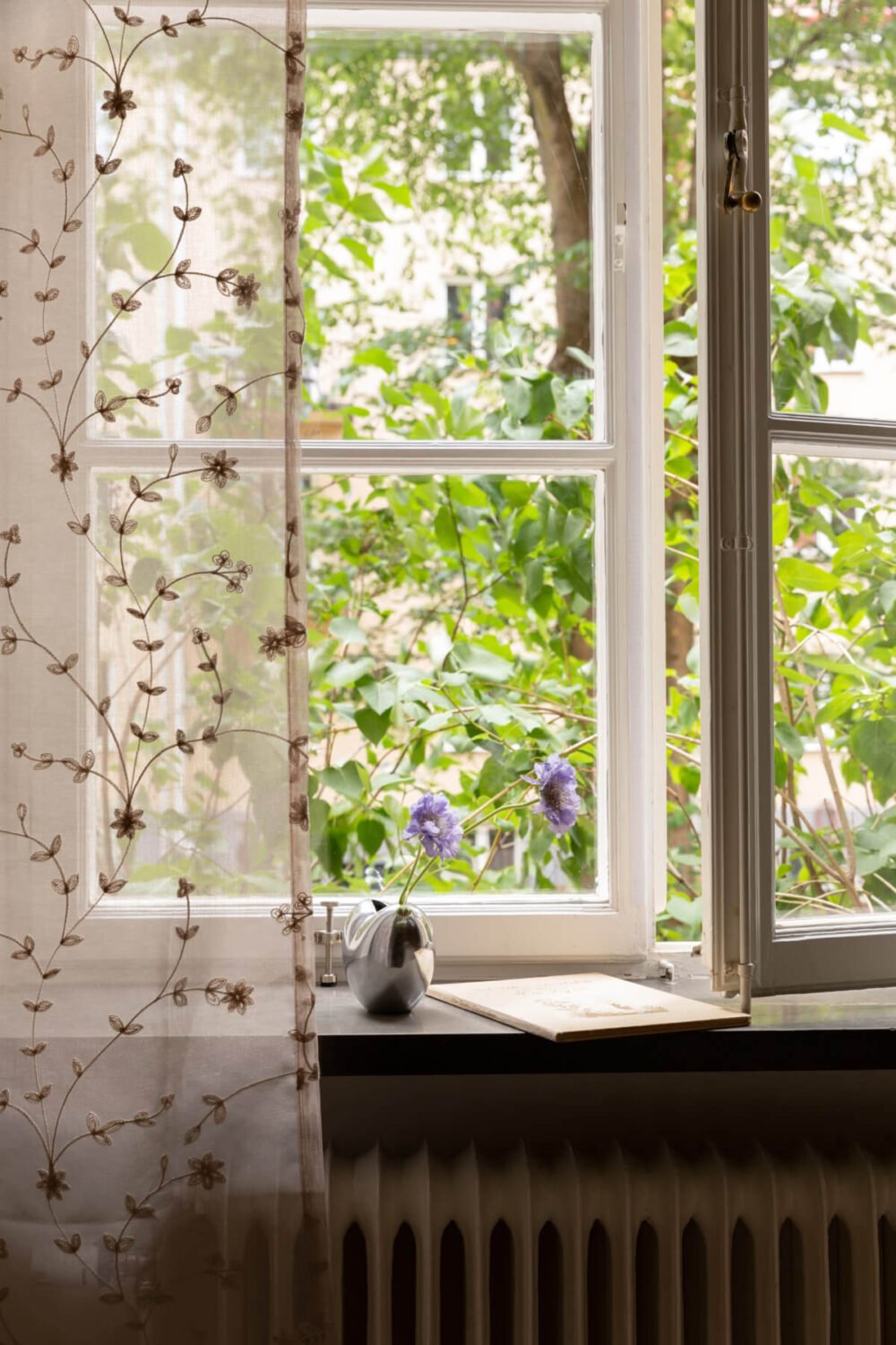 A 1930s Stockholm Apartment With Views of a Lush Garden 17 floral curtain bedroom window