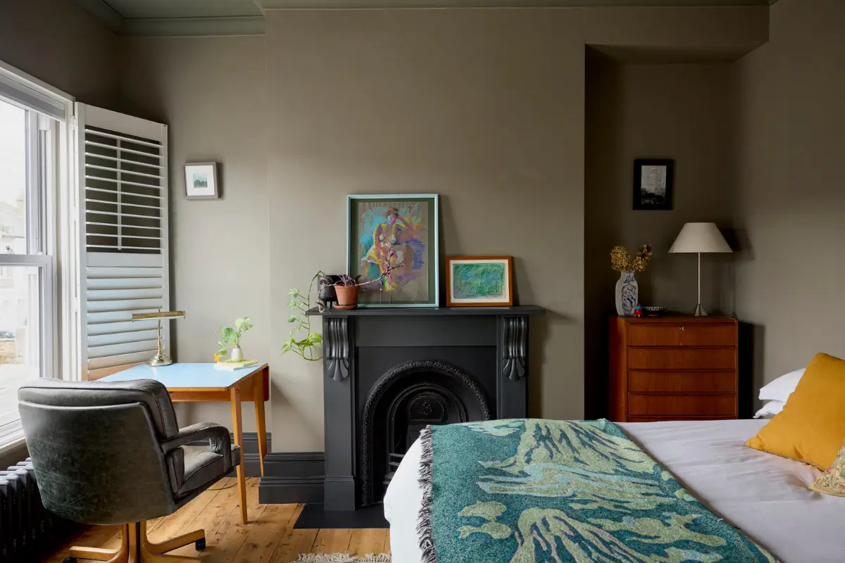 A Victorian Home with a Rich Color Palette and a Lush Garden 14 gray bedroom black fireplace desk