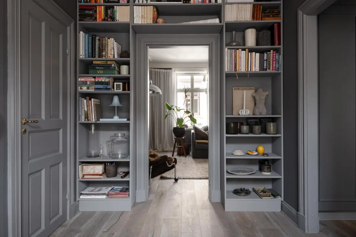 A Dark Gray Swedish Apartment with an Olive Green Kitchen 24 gray hall bookshelves fitted around doorframe