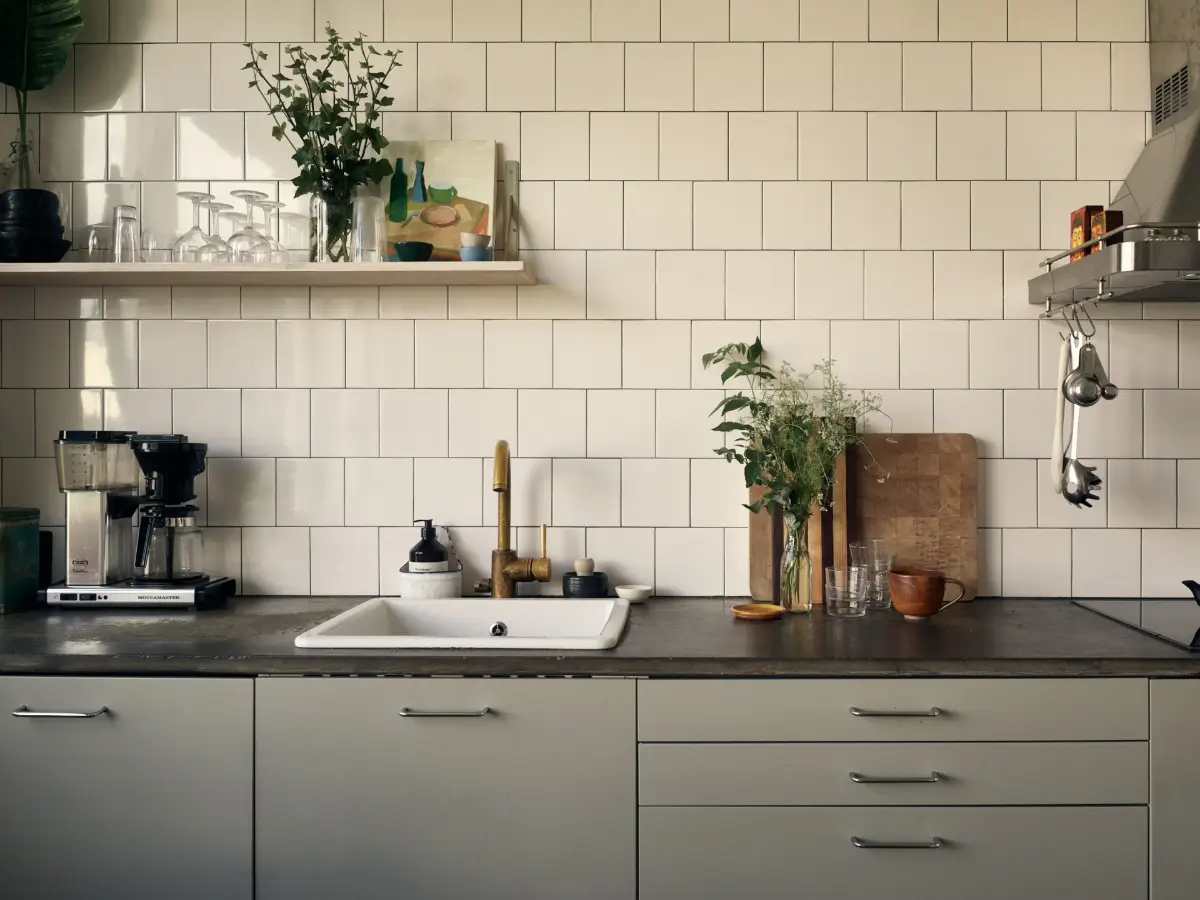 Industrial Elements in a 1960s Duplex Apartment in Stockholm 31 gray kitchen brass faucet