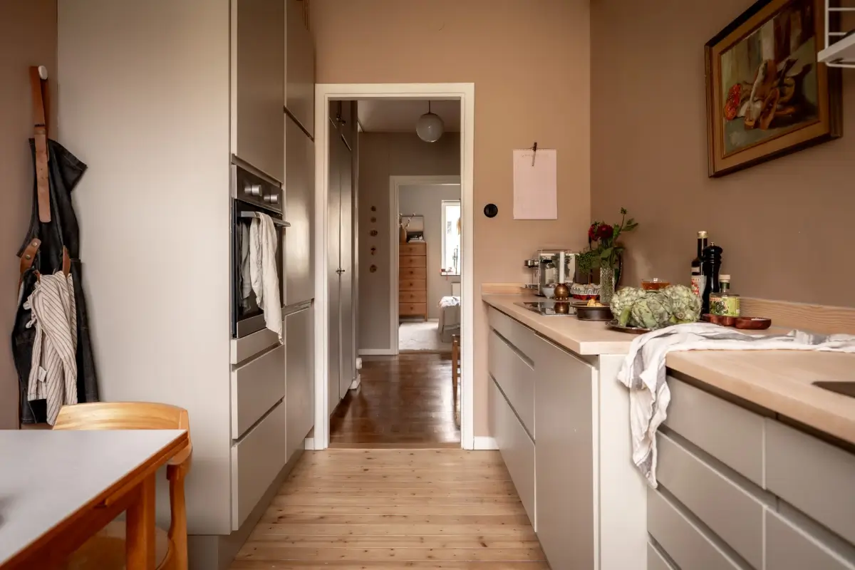 An Earthy Color Palette and Exposed Brick in a 1940s Apartment 16 gray kitchen cabinets dark beige walls nordroom