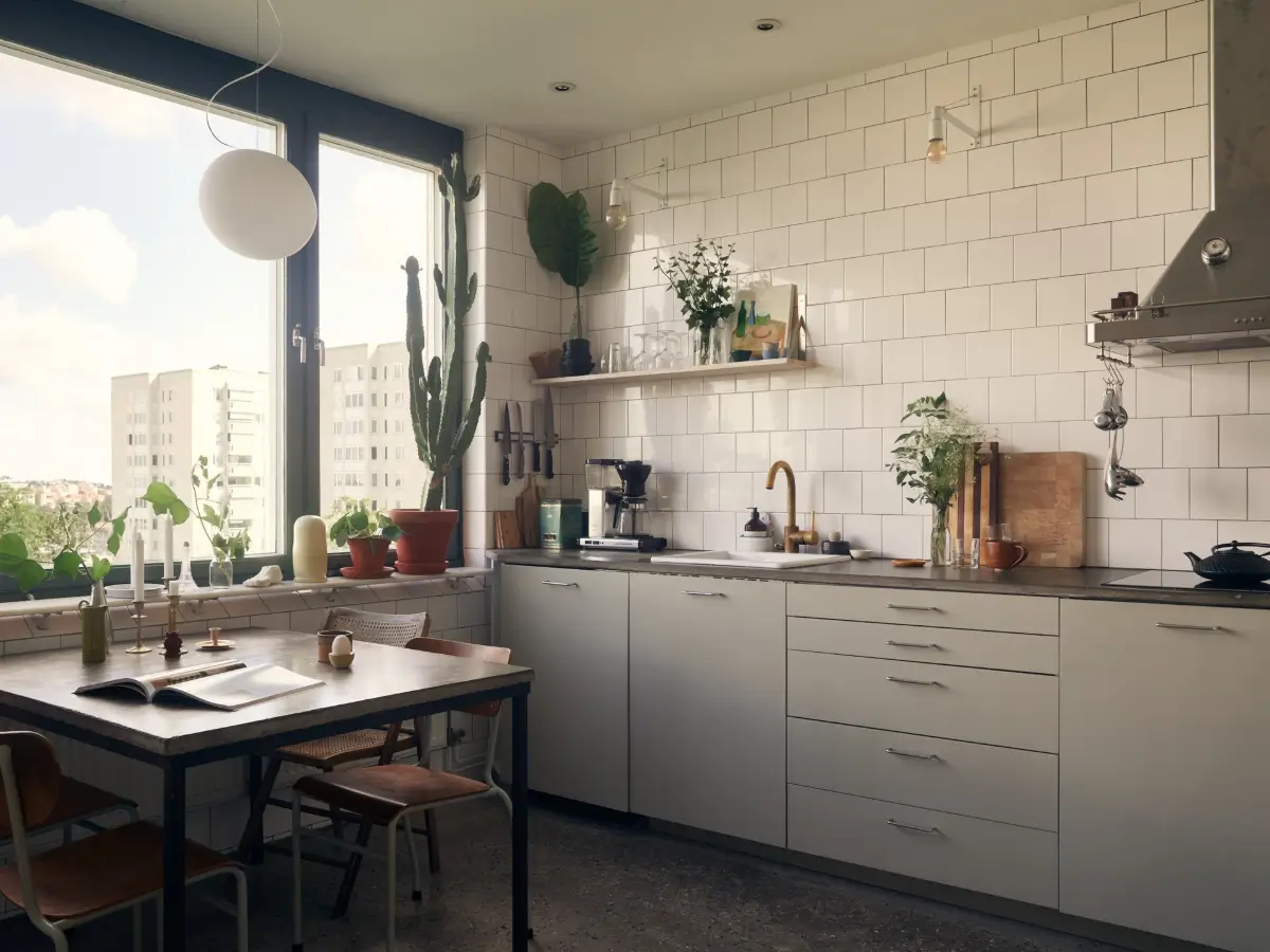 Industrial Elements in a 1960s Duplex Apartment in Stockholm 30 gray kitchen white tiles large window with table