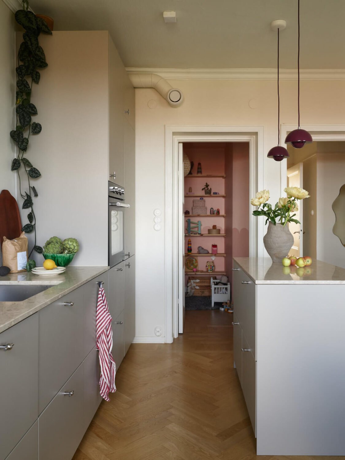 A Stockholm Apartment with a Butter-Yellow Bedroom 11 gray kitchen with small pink room