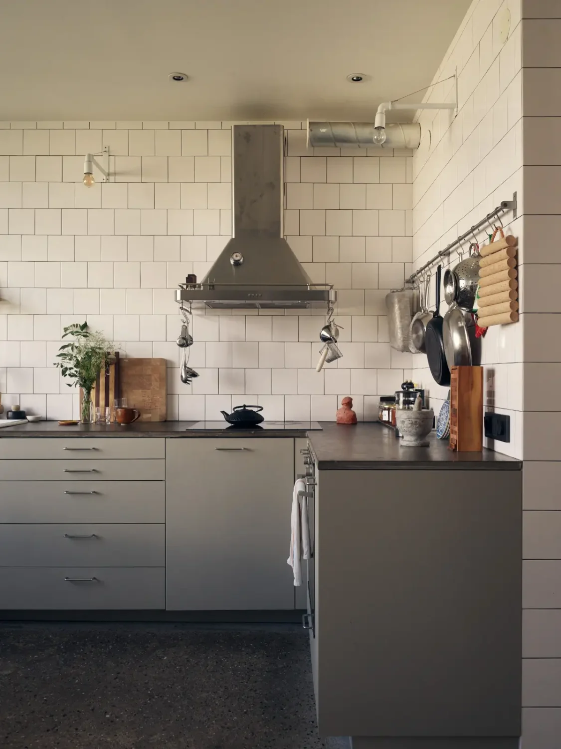 Industrial Elements in a 1960s Duplex Apartment in Stockholm 34 gray kitchen with white backsplash tiles