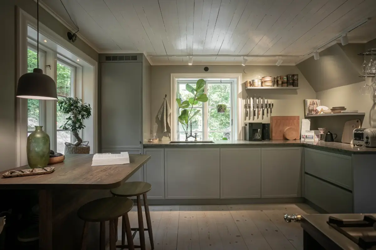 Modern Comforts and Historic Architecture in an 18th Century Home 4 gray kitchen with wooden bar table