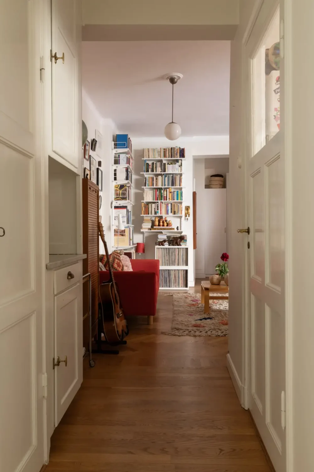 A Cozy 1920s Apartment Filled with Books, Art, and Music 17 hall built-in cabinets