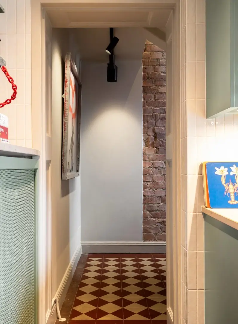 hall exposed brick checkerboard floor