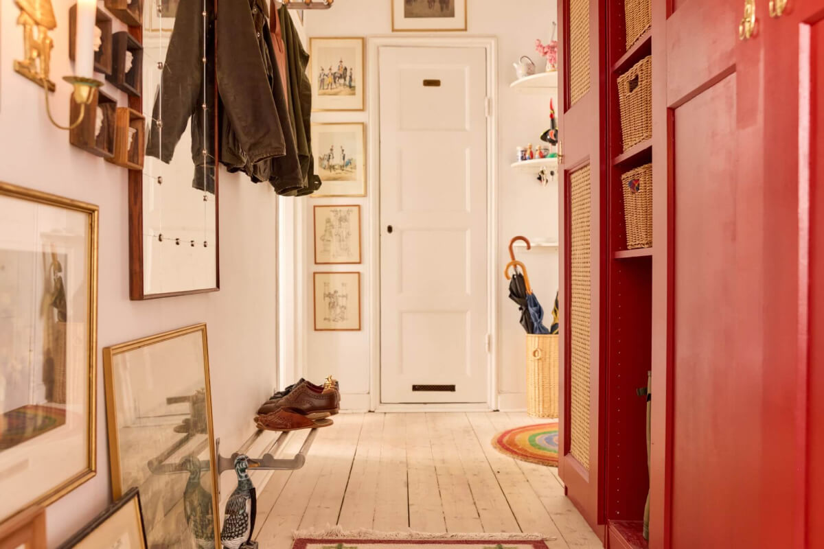 A Blue Living Room Filled with Art in a Swedish Apartment 19 hall wooden floorboards art red wardrobes A Blue Living Room Filled with Art in a Swedish Apartment