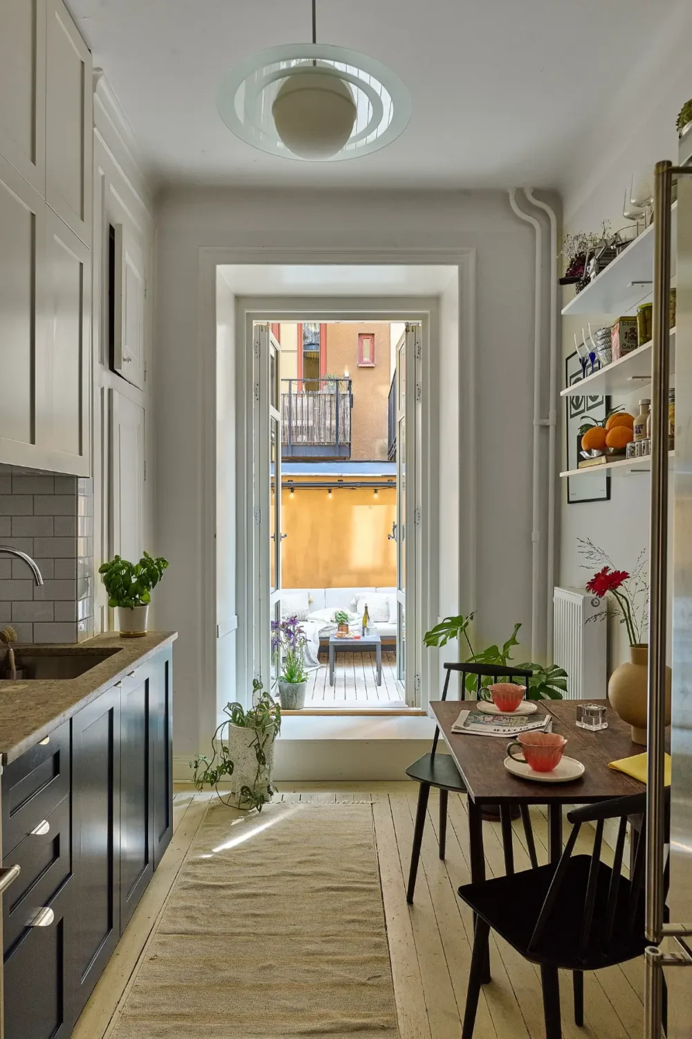 A Colorful Stockholm Apartment with a Large Terrace 11 kitchen blue and white cabinets small table