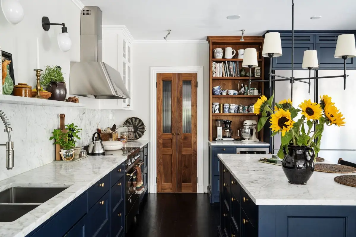 Scandinavian Design Meets The Hamptons in a Swedish Country House 17 kitchen dark blue cabinets marble countertop island nordroom