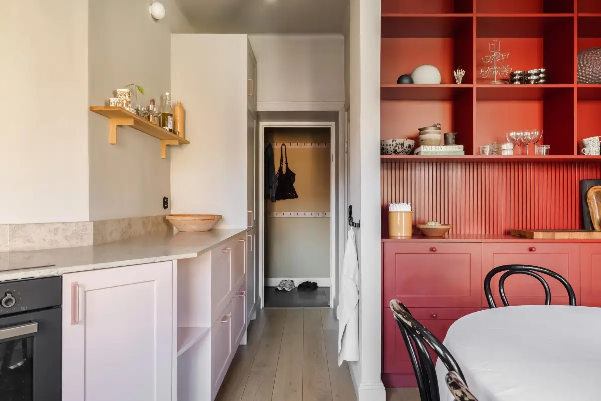 Colorful Rooms in a Practical Stockholm Family Apartment 4 kitchen light pink cabinets red built-in cabinet