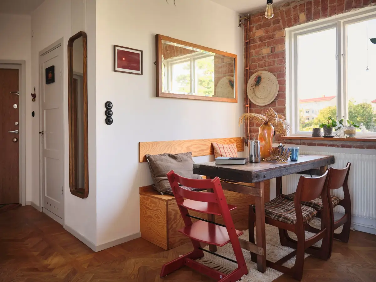 A Pink Bathroom and a Plywood Kitchen in a Stockholm Apartment 10 kitchen table brick wall