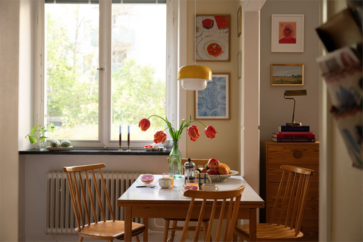 kitchen table yellow pendant Midcentury Design and Colorful Decor in a Charming Studio Apartment
