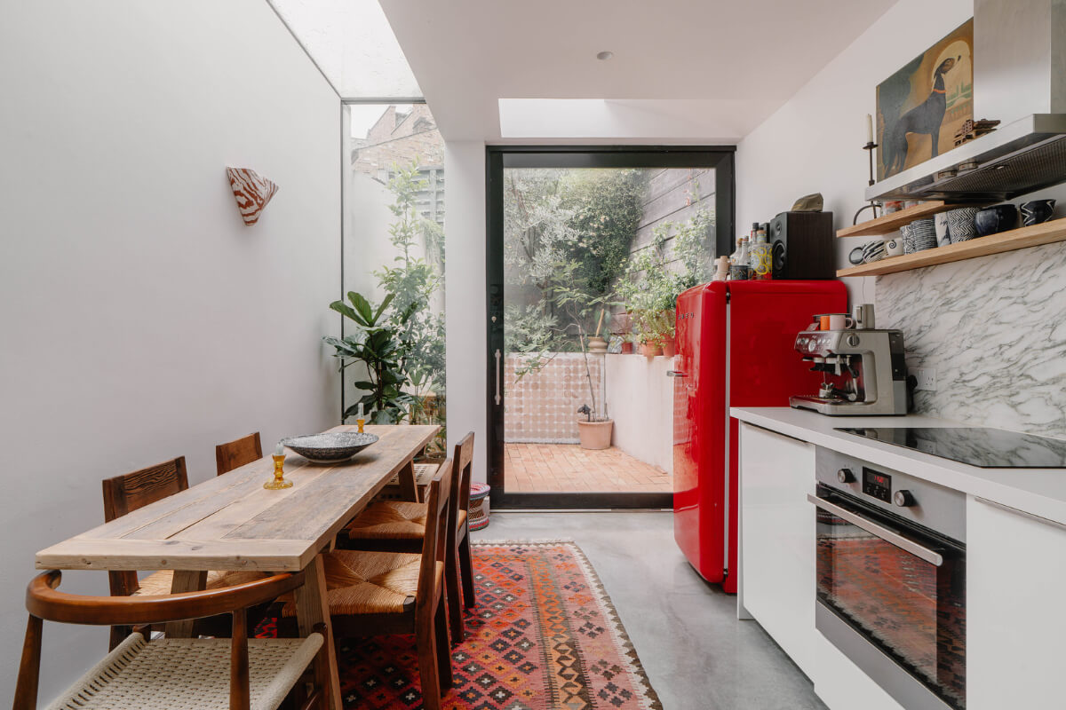 A Modern Ground-Floor Apartment with a Tiny Patio Garden 2 kitchen white cabinets skylights