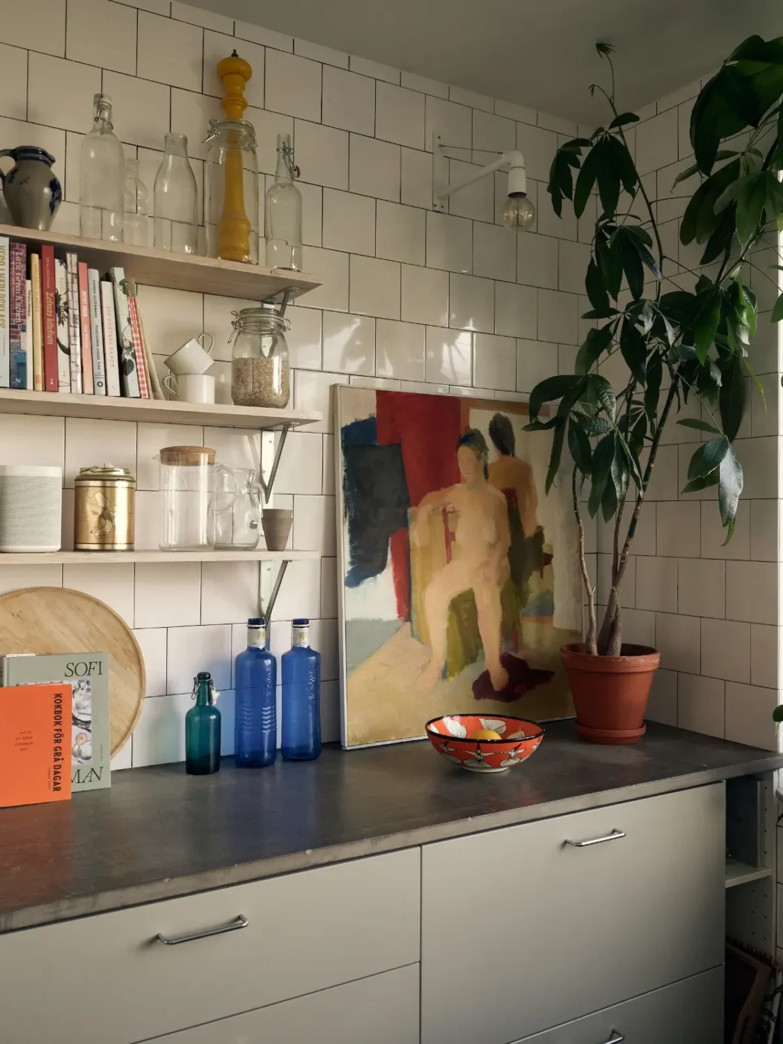 Industrial Elements in a 1960s Duplex Apartment in Stockholm 33 kitchen white tiles gray shelves