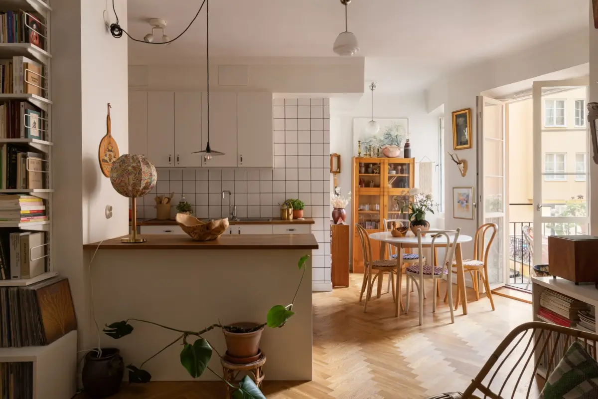 A Cozy 1920s Apartment Filled with Books, Art, and Music 8 kitchen with round dining table herringbone parquet floor