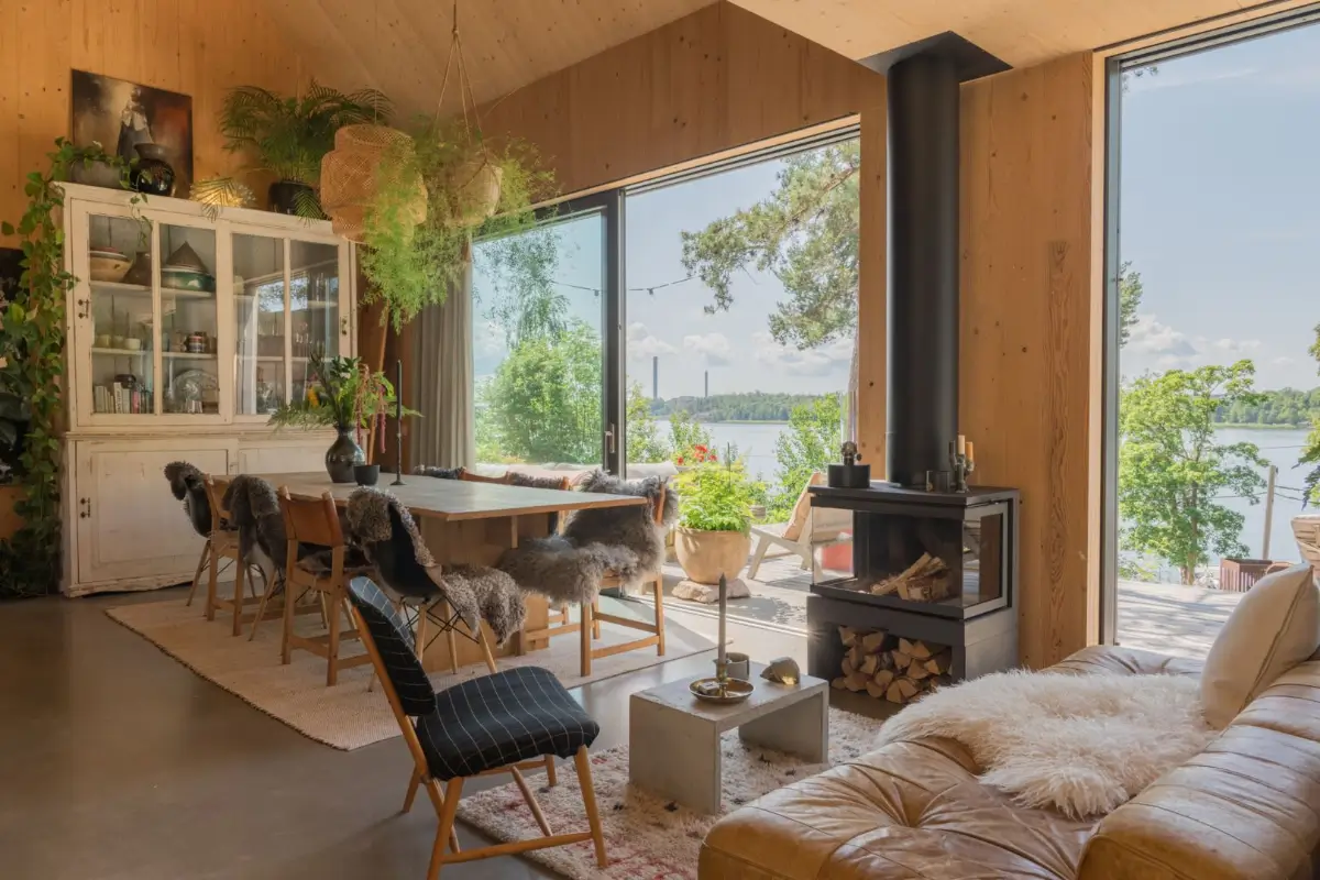 large wooden dining table wood burner large windows sea views