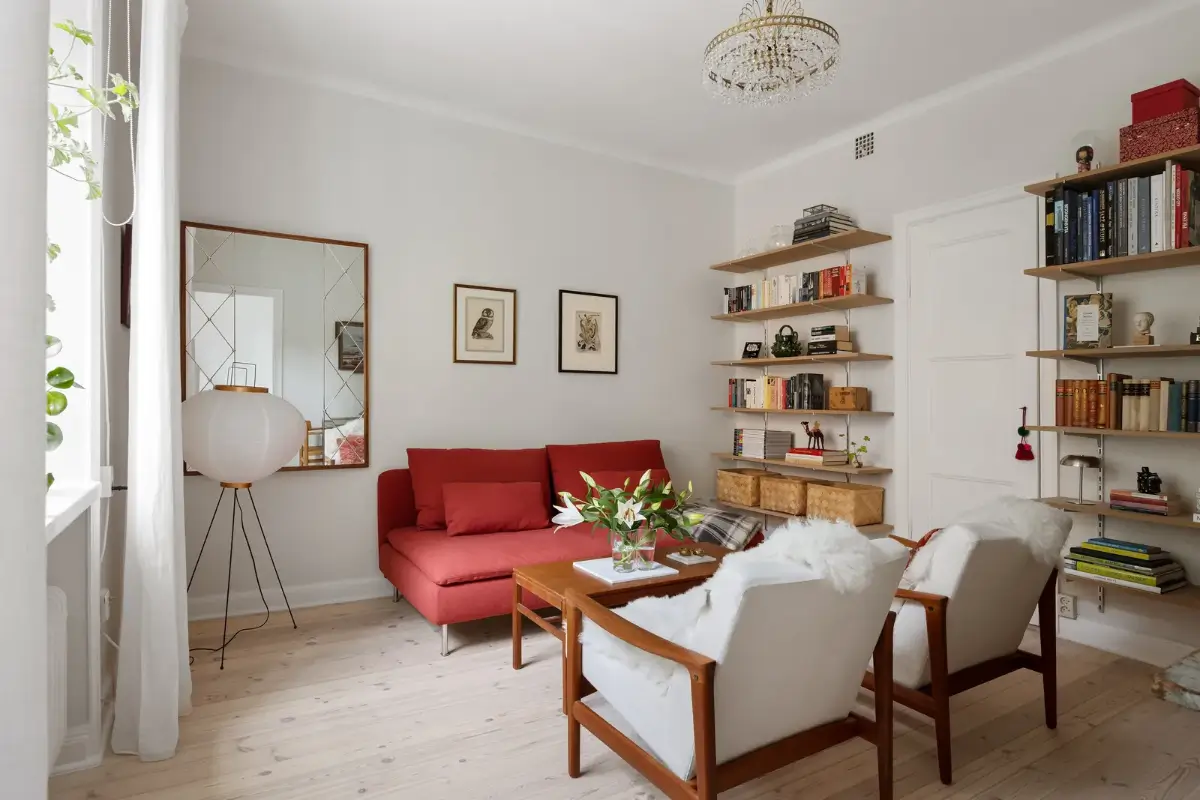 A Red Kitchen in a Small and Light Scandinavian Apartment 7 living room bookshelves red sofa