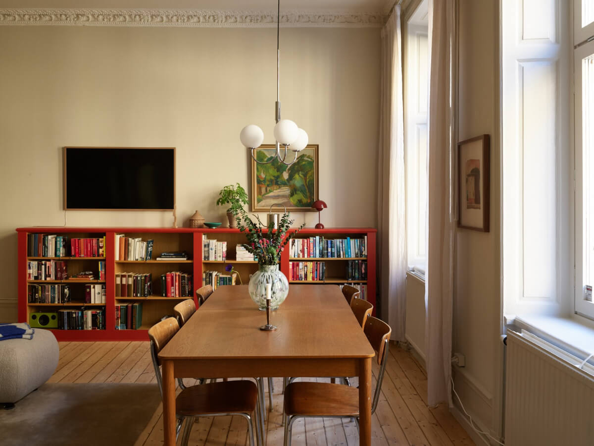 Blue and Red Color Accents in a Stylish Scandinavian Apartment 9 living room dining table red bookcases