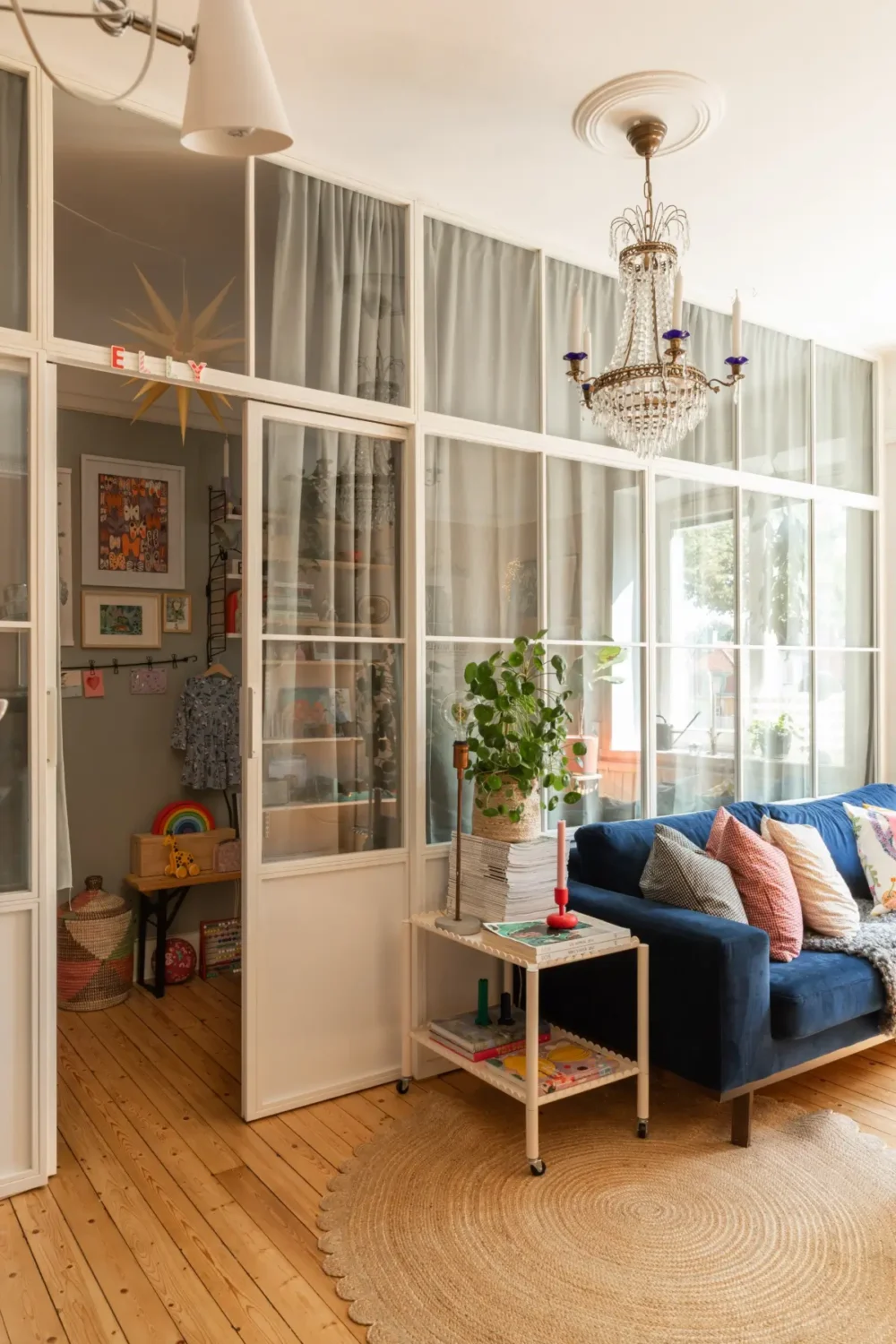 A Cozy Colorful Family Apartment with an Industrial Room Divider 5 living room glass wall nordroom