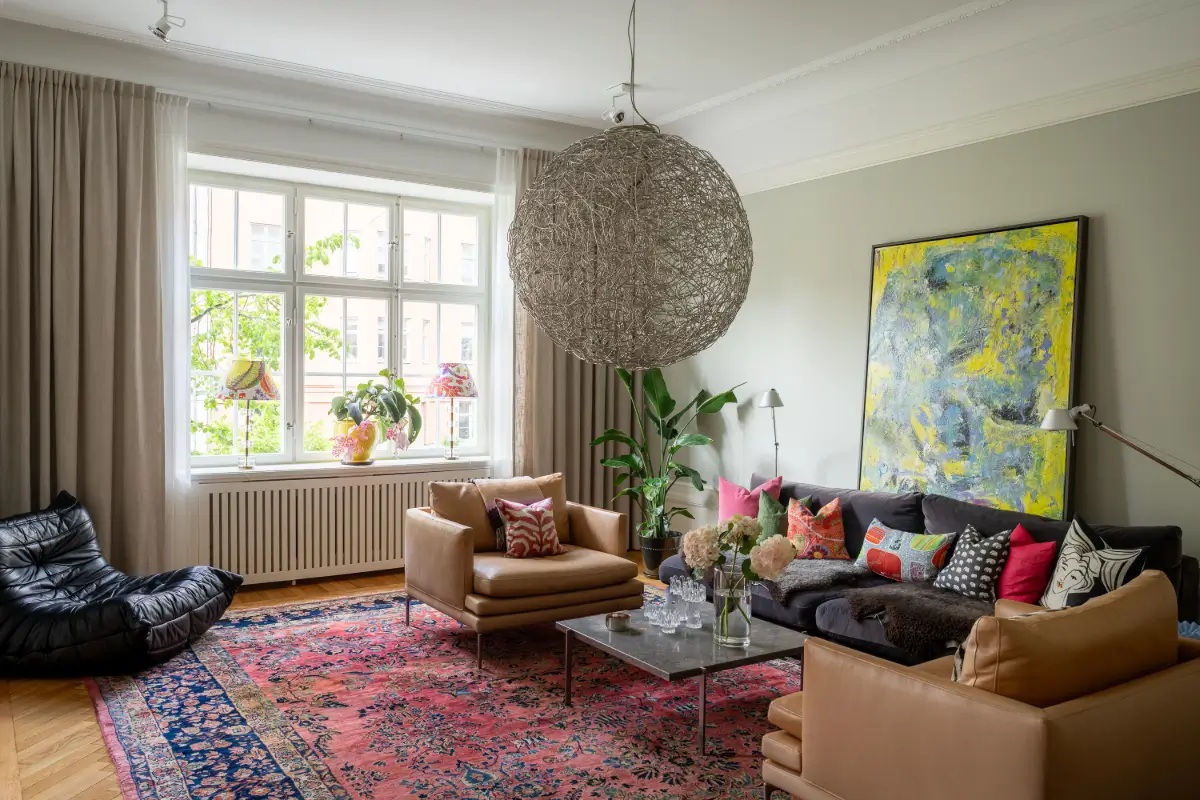 A Classic Stockholm Apartment with a Sky-Blue Kitchen 2 living room gray-green walls large colorful rug