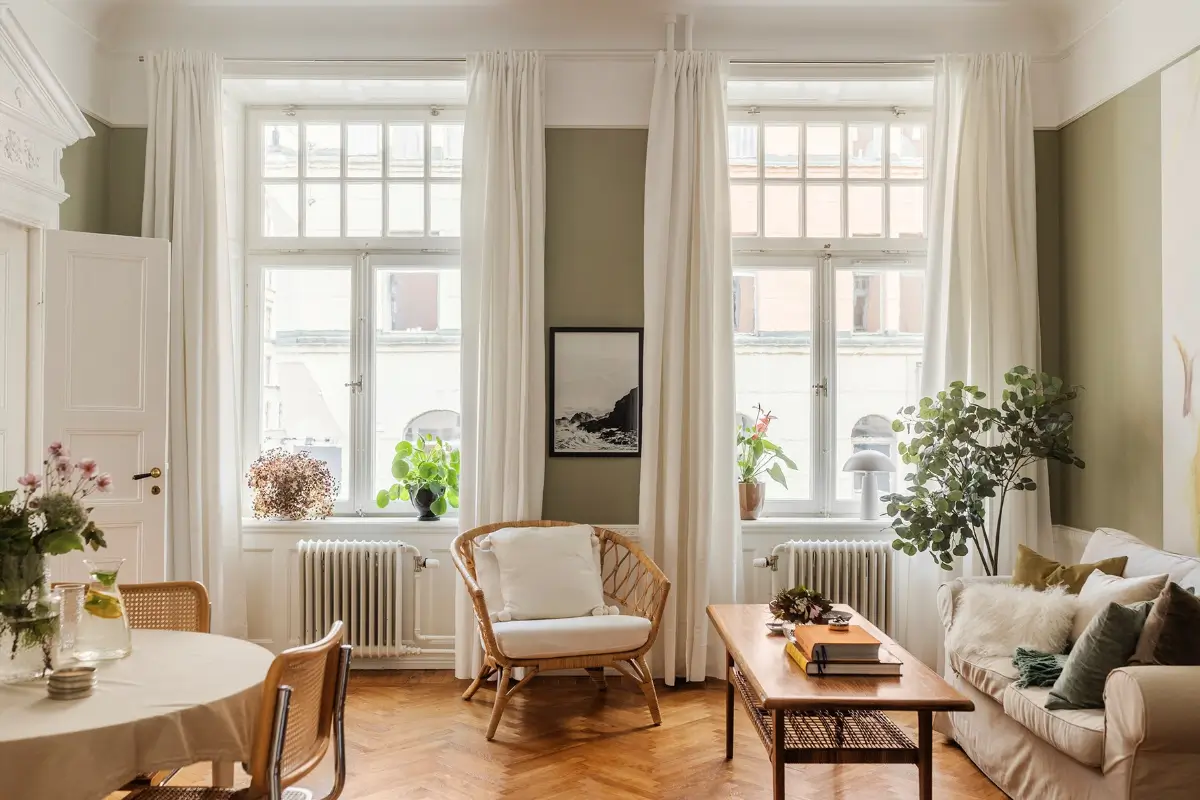 A Farrow & Ball Palette in an Art Nouveau Stockholm Apartment 1 living room large windows green walls high baseboards parquet herringbone floor nordroom
