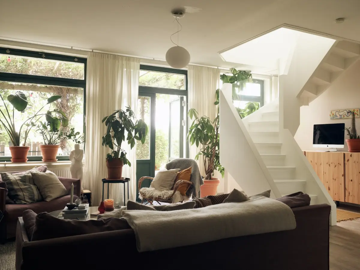 Industrial Elements in a 1960s Duplex Apartment in Stockholm 1 living room large windows white staircase